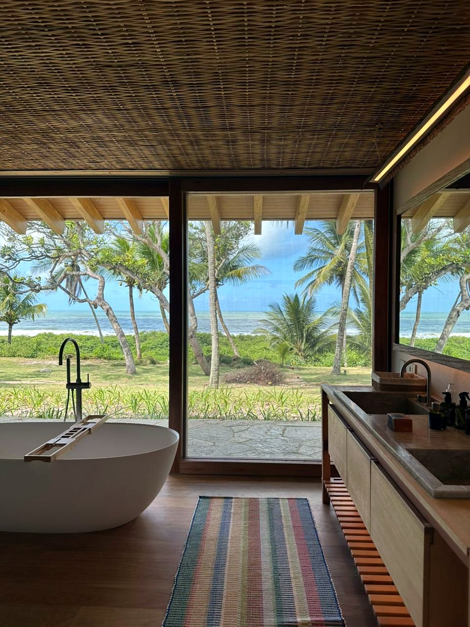 Bathroom opening to the palms and the sea