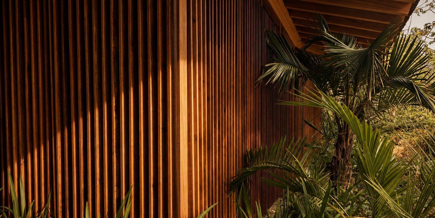 Timber brise and palms along the façade